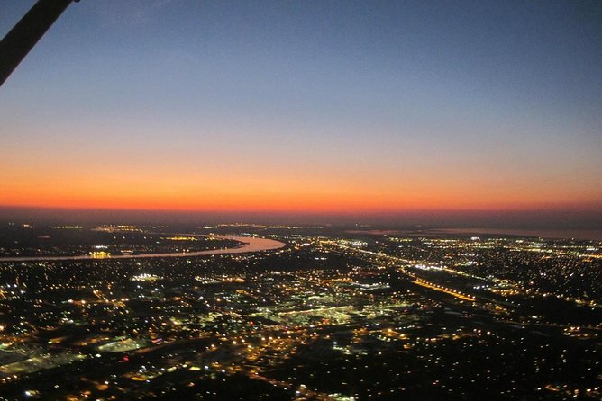New Orleans Night Sightseeing Flight - Downtown lights: Superdome and Smoothie King Center from above